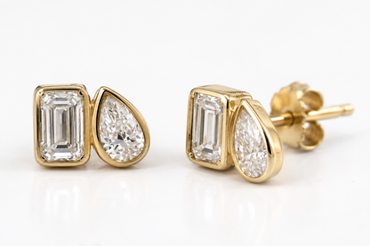 Pair of yellow gold Toi et Moi bezel-set lab diamond stud earrings