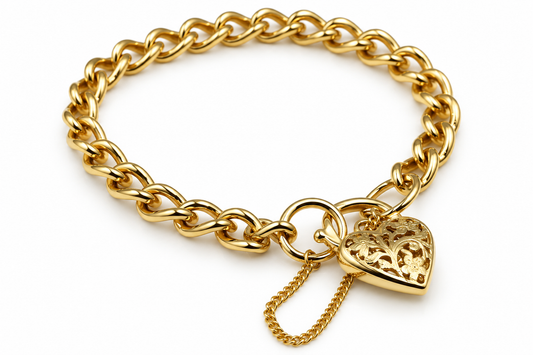 9ct yellow gold curb bracelet with decorative heart padlock and attached safety chain