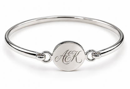 Sterling silver disc bangle showing an ornate AEK monogram engraving example.