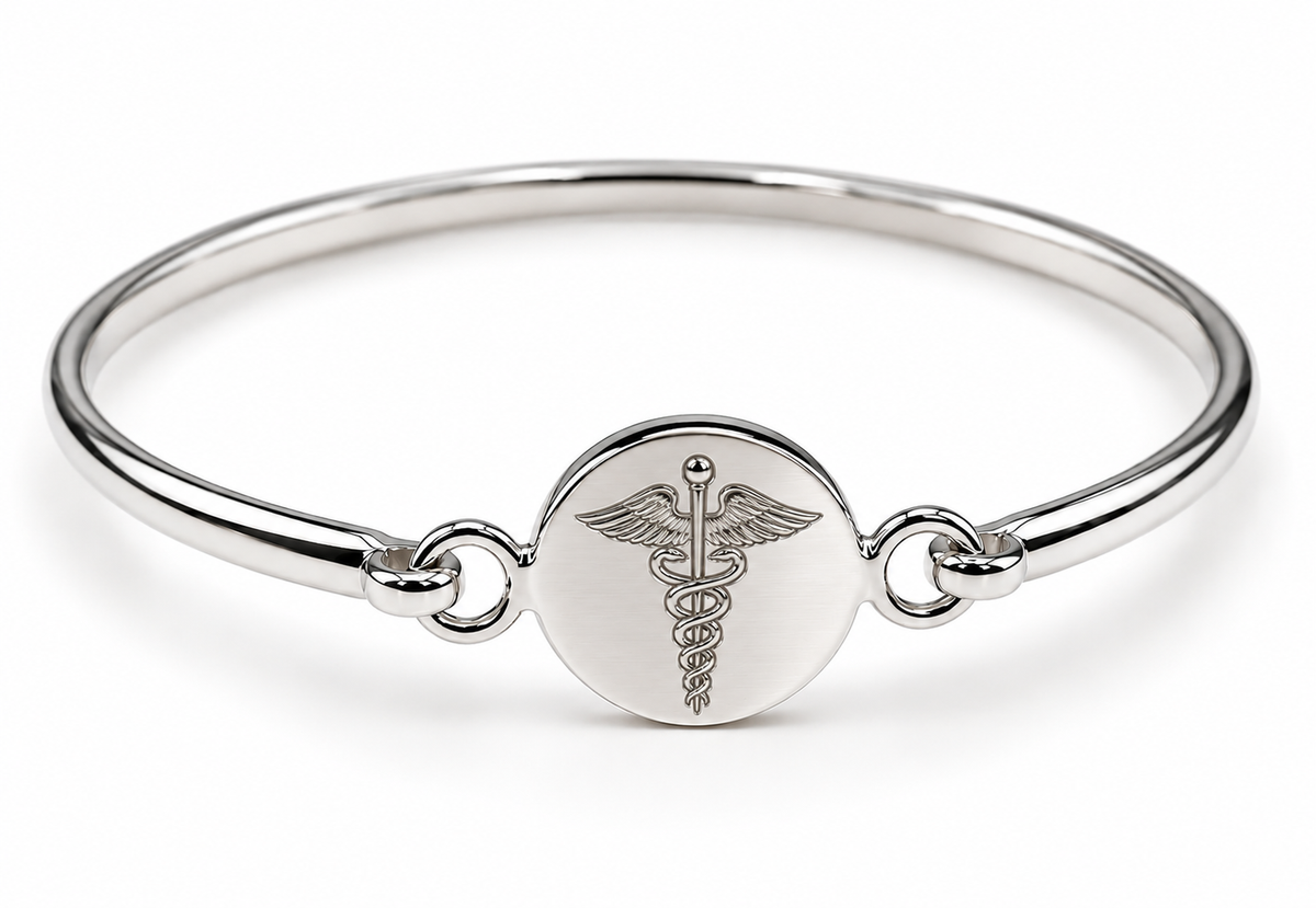 Sterling silver disc bangle showing a caduceus symbol engraving example.